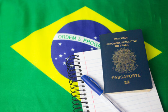 Brazilian flag and passport with notepad and pen - Powered by Adobe