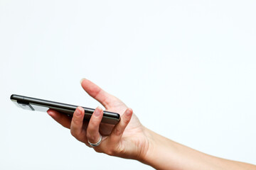a woman hand holding a cell phone against a clean white background. mental toll of digital consumption, using the brain rot metaphor for impact. digital detox woman phone white background