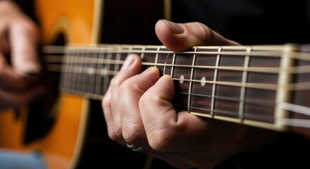 Fototapeta premium Close-up of adult caucasian male playing acoustic guitar with precision and focus