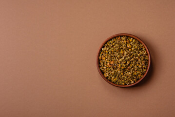 Dried chamomile flowers, herbal tea in a bowl for a hot morning drink. Dried chamomile