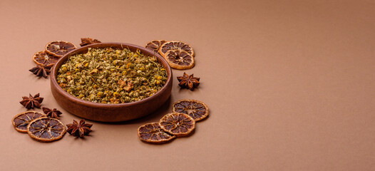 Dried chamomile flowers, herbal tea in a bowl for a hot morning drink. Dried chamomile