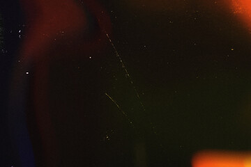 Light overlay, orange warm color. Blurry spots. Old film light leak texture with scratches, grain, noise and dust. Perfect as background or overlay for photo editing, video design, and digital art.
