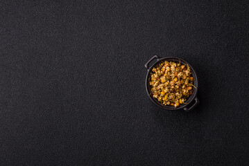 Dried chamomile flowers, herbal tea in a bowl for a hot morning drink. Dried chamomile