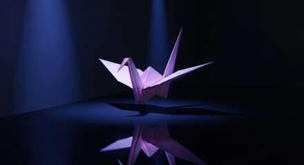 Illuminated origami crane, mirrored on reflective surface against dark background