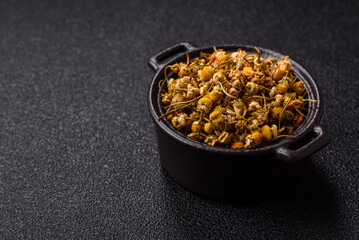 Dried chamomile flowers, herbal tea in a bowl for a hot morning drink. Dried chamomile
