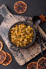 Dried chamomile flowers, herbal tea in a bowl for a hot morning drink. Dried chamomile