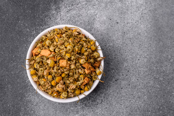 Dried chamomile flowers, herbal tea in a bowl for a hot morning drink. Dried chamomile