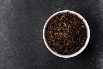 Golden black tea, dried leaves of a Chinese or Indian breakfast drink. Black tea dried leaves