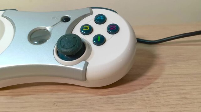 Gaming controller poised for action in nostalgic retro gaming session, bringing back memories of classic gameplay and exciting digital adventures, ready to play