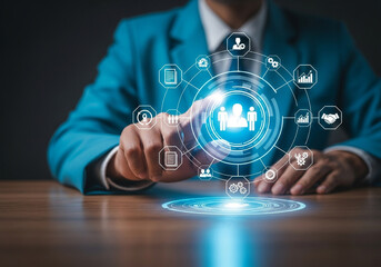 Businessman touching a digital interface with icons representing human resources, data, and business growth, symbolizing team management and corporate strategy
