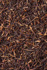 Golden black tea, dried leaves of a Chinese or Indian breakfast drink. Black tea dried leaves
