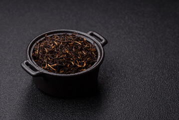 Golden black tea, dried leaves of a Chinese or Indian breakfast drink. Black tea dried leaves