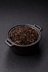 Golden black tea, dried leaves of a Chinese or Indian breakfast drink. Black tea dried leaves