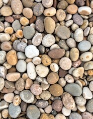 Close-up of various smooth, colorful, and rounded pebbles