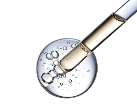 Clear serum being dispensed from dropper into a circular dish