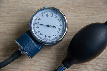 On the table is a monitor and a bulb of a manual tonometer. For measuring blood pressure in people.