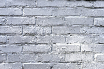 background, brick wall painted white. brick wall facade texture. old bricks in an exterior uneven wall of a house. masonry, construction, repair, restoration. space for text