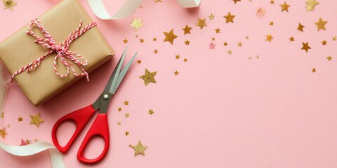 Festive gift wrapping essentials with red scissors on pink background for creative holiday designs