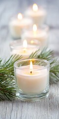 Serene ambiance with modern candles in glass holders aligned on wooden surface