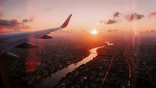 Stunning aerial view of a cityscape at sunset from airplane window