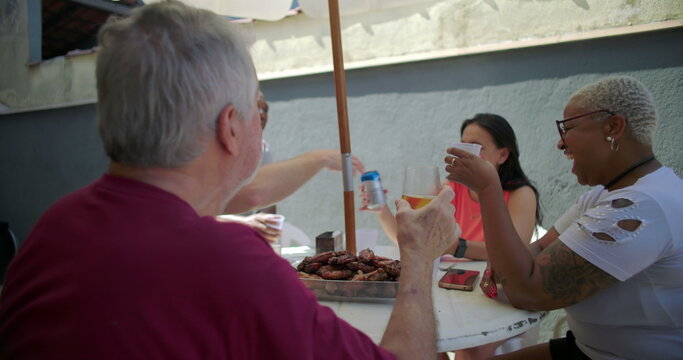 Group of friends raising glasses in a toast at a backyard barbecue, celebrating connection and togetherness during a cheerful outdoor gathering - Powered by Adobe