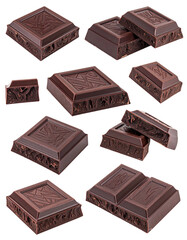 Dark chocolate bars in various sizes and angles, scattered against a black background.  Many pieces are broken or separated.  The dark chocolate displays a textured surface