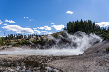 Mud Caldron. Mud Volcano area, Yellowstone National Park, Wyoming. A mud volcano or mud dome is a landform created by the eruption of mud or slurries, water and gases