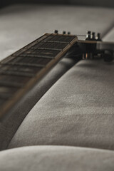 Musical moments captured in a cozy setting with guitar resting on a couch