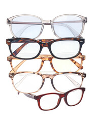 Stacked eyeglasses in various styles and colors