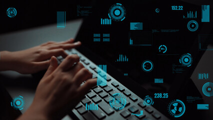 Hands typing on a laptop amidst a backdrop of futuristic data visualizations, showcasing technology and innovation in a modern work environment. Xenic