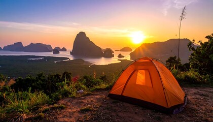 Camping tent on mountain peak with stunning landscape during sunrise or sunset