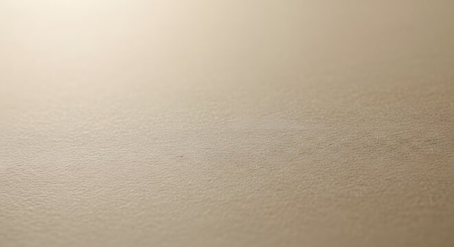 Subtle gradient of light beige color, creating a soft and minimalist background with a delicate texture and a sense of calm and tranquility