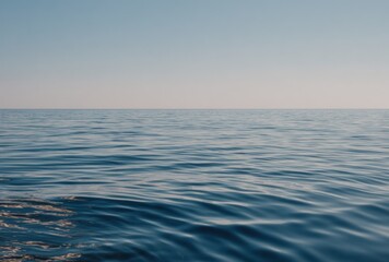 Obraz premium A tranquil view of calm blue ocean water meeting a pale, cloudless sky