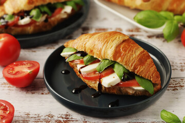 Croissants with mozarella cheese and tomatoes in caprese style