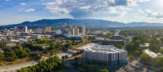 Aerial view of Reno, Nevada, showcasing downtown high rises, casinos with a white dome, highways,...