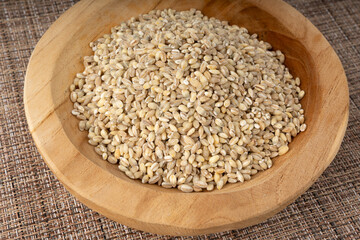 Pearl barley grains. Raw peeled cereal pile texture, organic pearl barley
