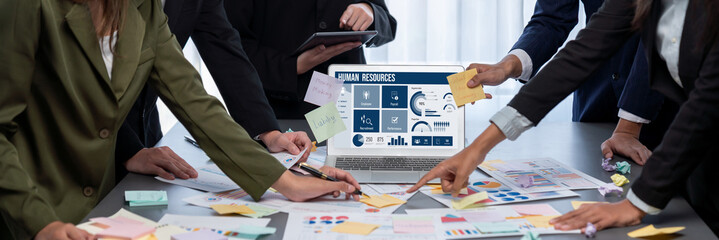 Analyst team use sticky note for creative and analytic brainstorm for business idea with BI data dashboard on laptop screen. Analysis financial data visualization tech for marketing strategy. Prodigy