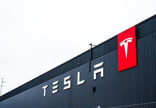 Stockholm, Sweden - March 09 2024: tesla factory exterior with bold red logo on dark facade.