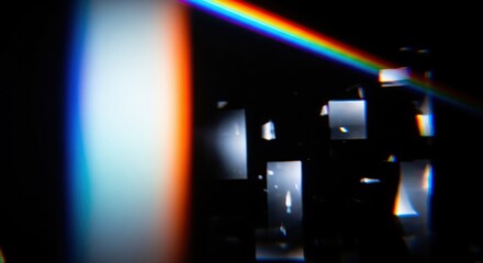 Prismatic light dispersion through optical elements on a dark background