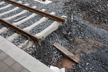 Disruption on the railroad and railway track. Part of rail is missing - obstacle and barrier on the line. Transport incident and damage or infrastructure construction. Shallow focus