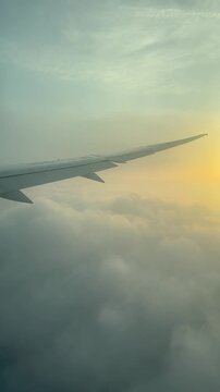 View from the airplane window of the rising sun, View of the sun rising over thick clouds