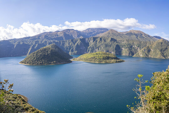 Cotacachi, Ecuador &ndash; August 5, 2025: Cuicocha Lagoon in the Ecuadorian Andes, surrounded by vegetation. In the background, the majestic Cotacachi Volcano with its summit hidden among the clouds.