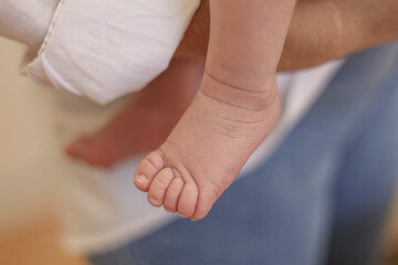 A close-up shot shows a newborn baby's feet resting near a plush teddy , soft and peaceful.