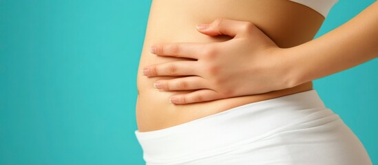 Young pregnant woman gently touching her belly