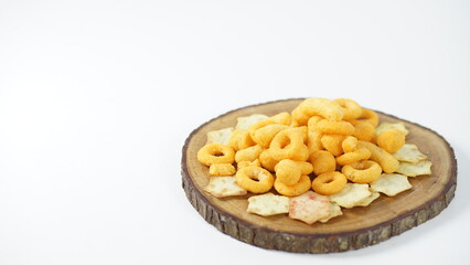 Elevated snack presentation featuring golden corn rings and crackers on wood