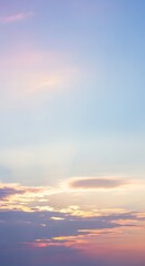 Fototapeta premium Soft Pastel Sunset Sky with Wispy Clouds and Gentle Hues sky background of Portrait