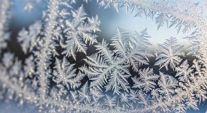 Close up of intricate frost patterns forming on a window pane during a cold winter day season