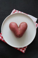 Heart shaped potato representing love for healthy food