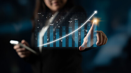 A business professional uses advanced technology to analyze financial data. The holographic display...