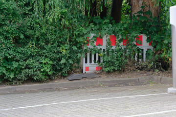 Roadside construction barrier in bushes beside the sidewalk